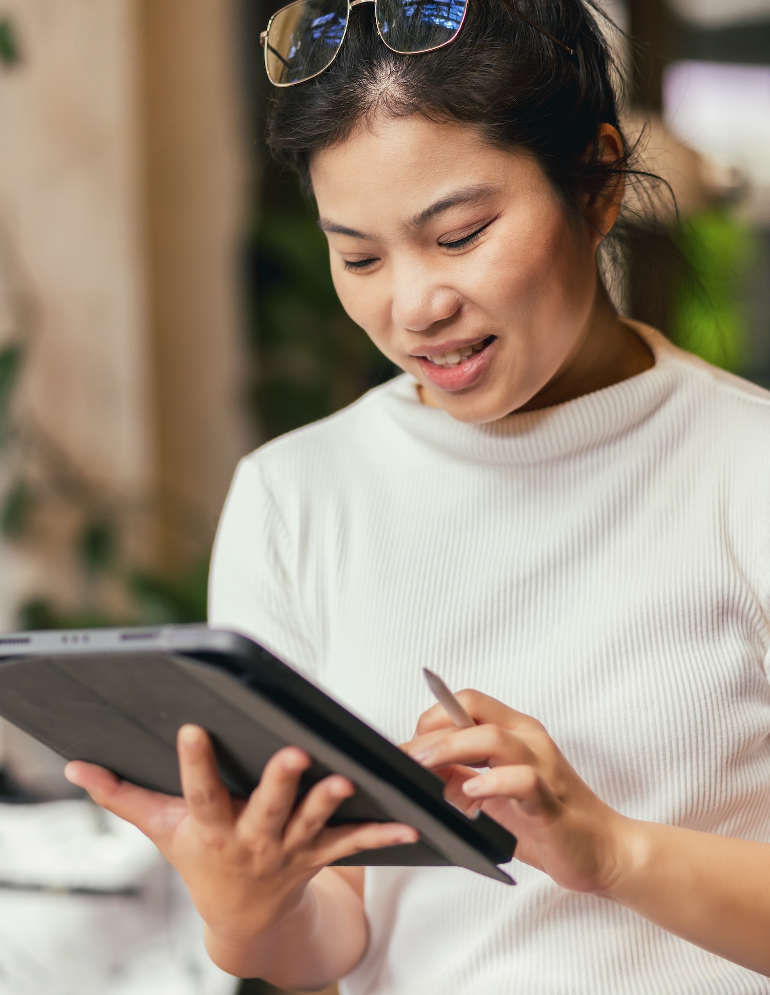 Business owner reviewing Modula sales on a tablet