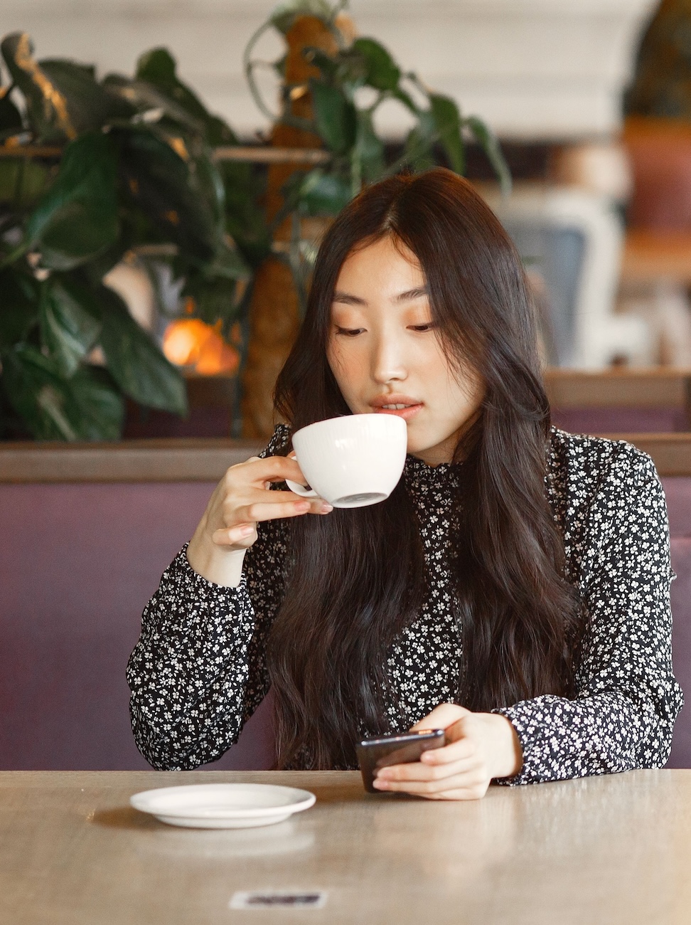 Guest ordering from a phone at a cafe table